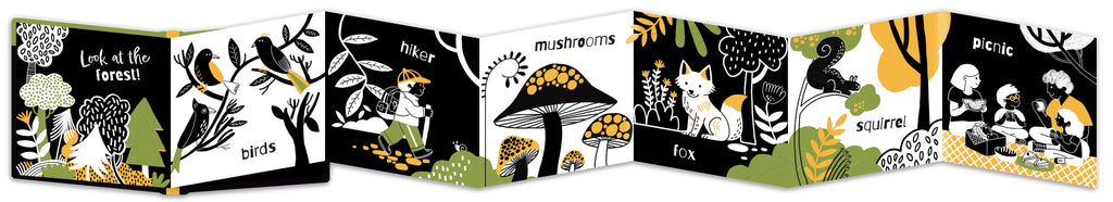 Fold out children's book with animal illustrations on a black background