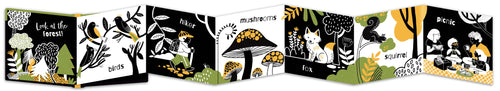 Fold out children's book with animal illustrations on a black background