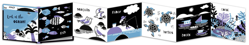 A fold out illustrated children's book shown open side by side, featuring ocean-themed black, white, and blue illustrations such as fish, sea life, a fisherman, turtles, and boats.