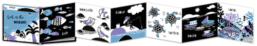 A fold out illustrated children's book shown open side by side, featuring ocean-themed black, white, and blue illustrations such as fish, sea life, a fisherman, turtles, and boats.