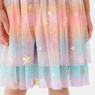 Pastel-colored sheer fabric with star patterns, held by a person.