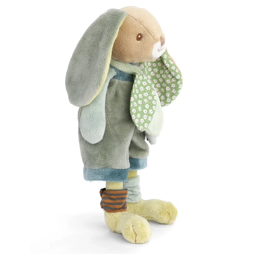 Stuffed toy rabbit holding a flower on a white background