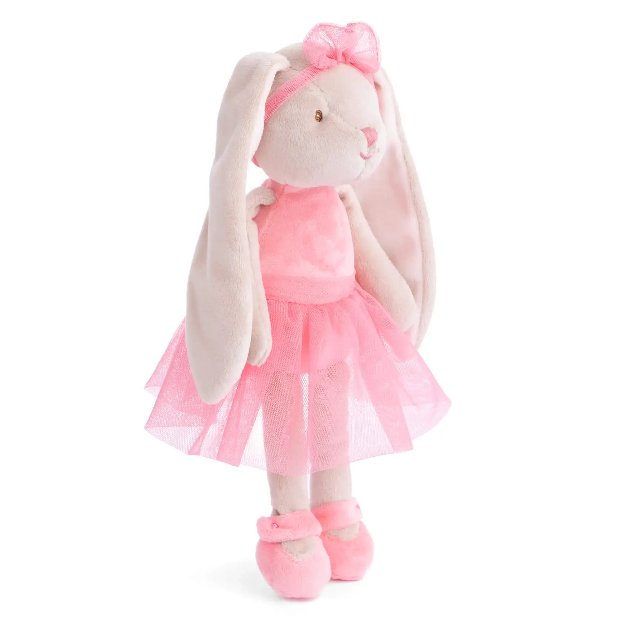 Plush toy rabbit in a pink dress and ballet shoes on a white background