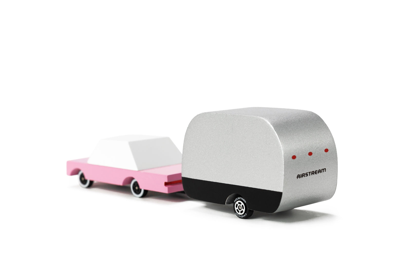 Model of a pink car with a silver trailer on a white background