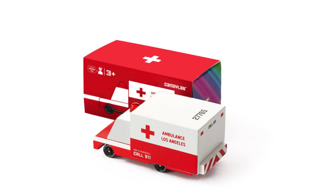 Model ambulance toy with packaging on a white background