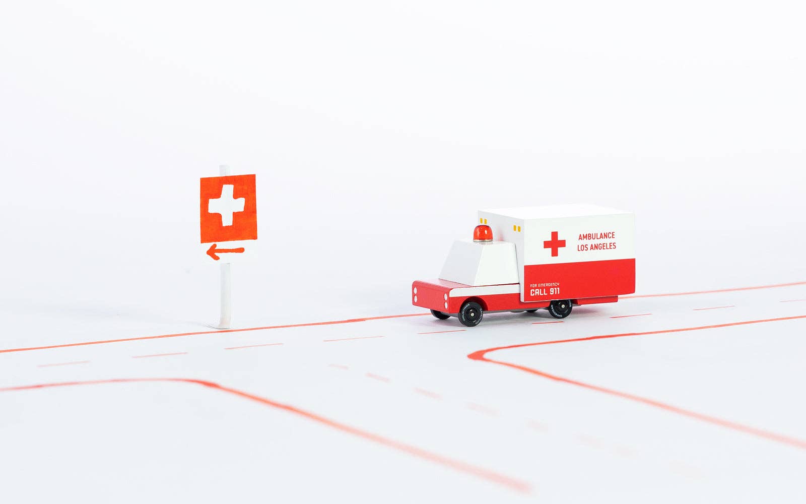 Model ambulance and sign on a white background