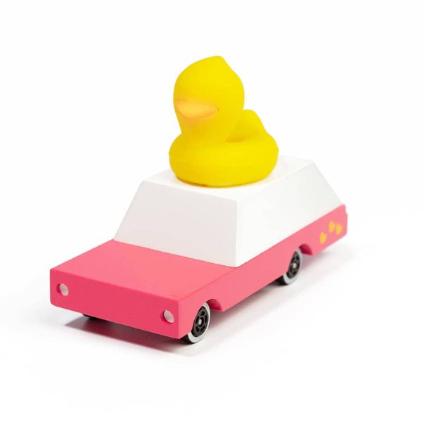 Toy car with a yellow duck on top against a white background