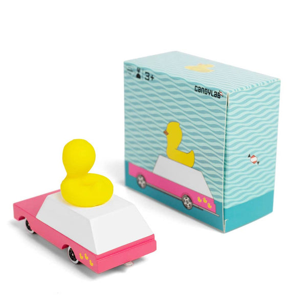 Yellow duck in a pink car with a matching box on a white background
