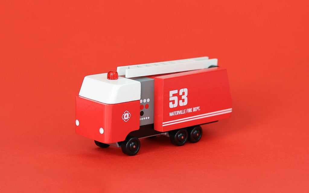Red toy fire truck with ladder on a red background