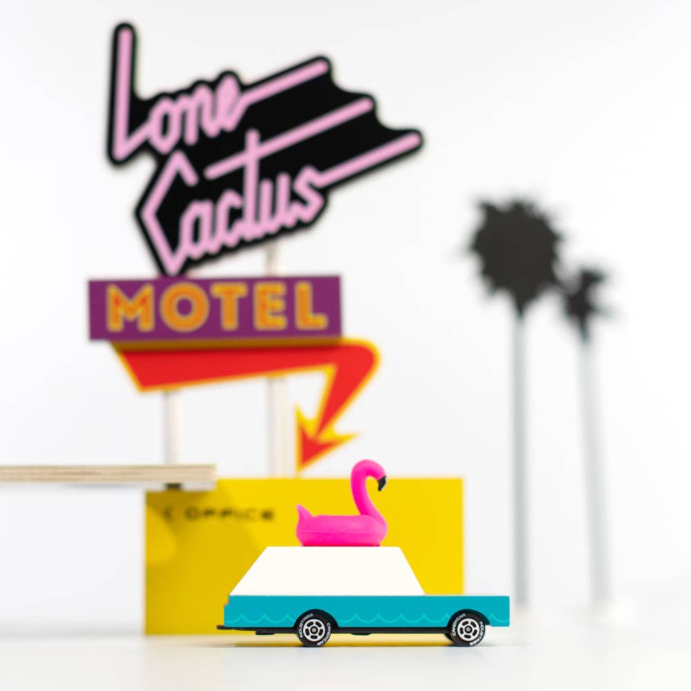 Colorful neon sign for 'Lone Cactus Motel' with a cartoon truck and pink flamingo on a white background.