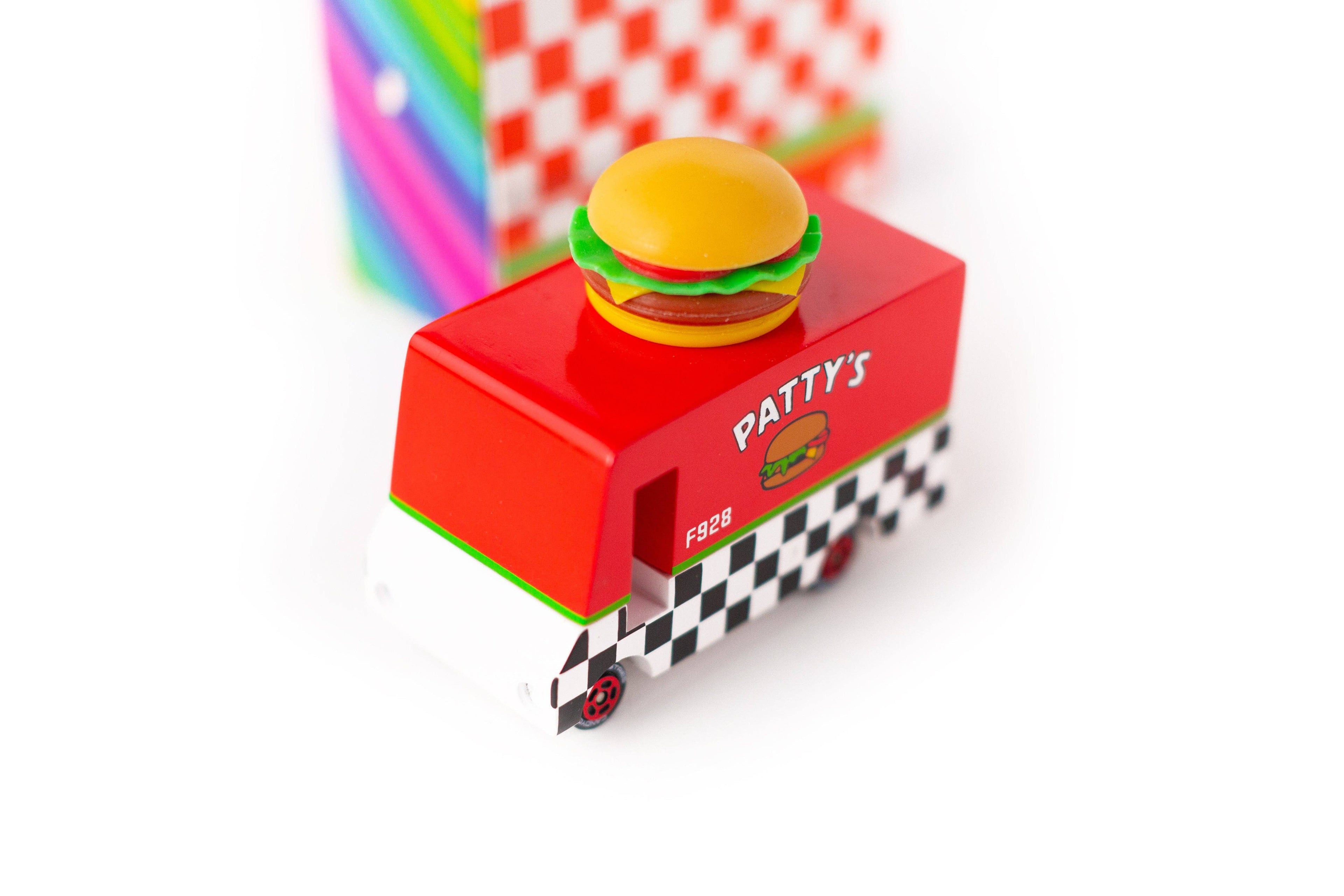 Toy burger truck with a hamburger on top, set against a colorful background.