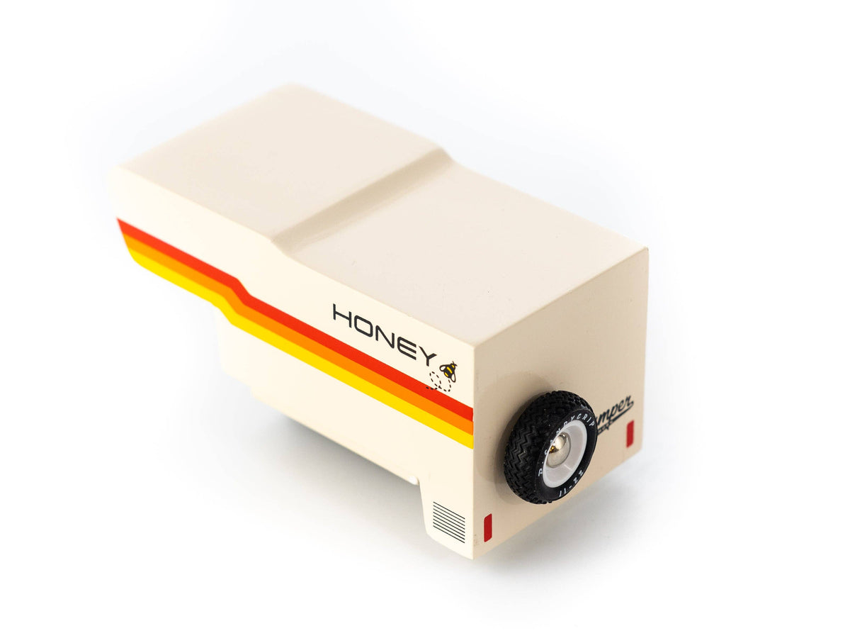Small model of a camper van with 'Honeybee Camper' branding on a white background