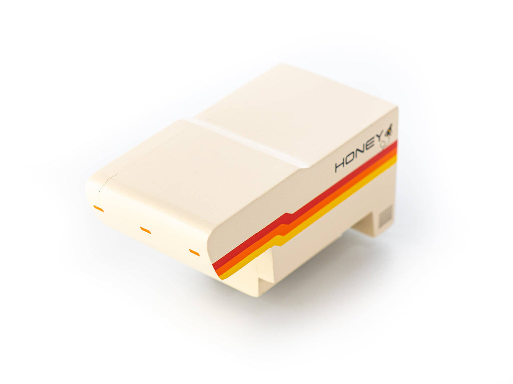 Small model of a camper van with 'Honeybee' branding on a white background