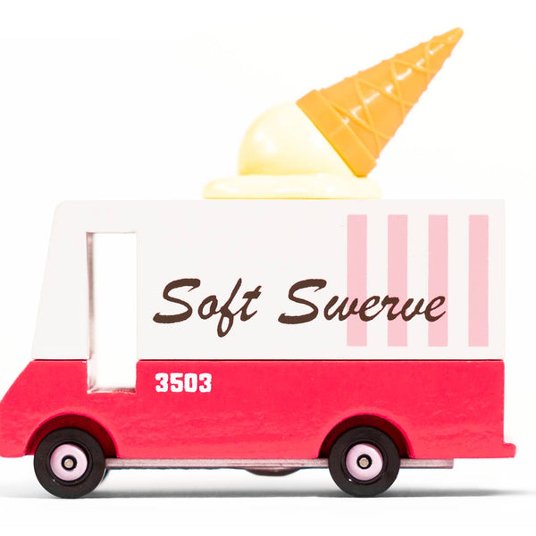 Toy ice cream truck with a soft serve cone on top against a white background