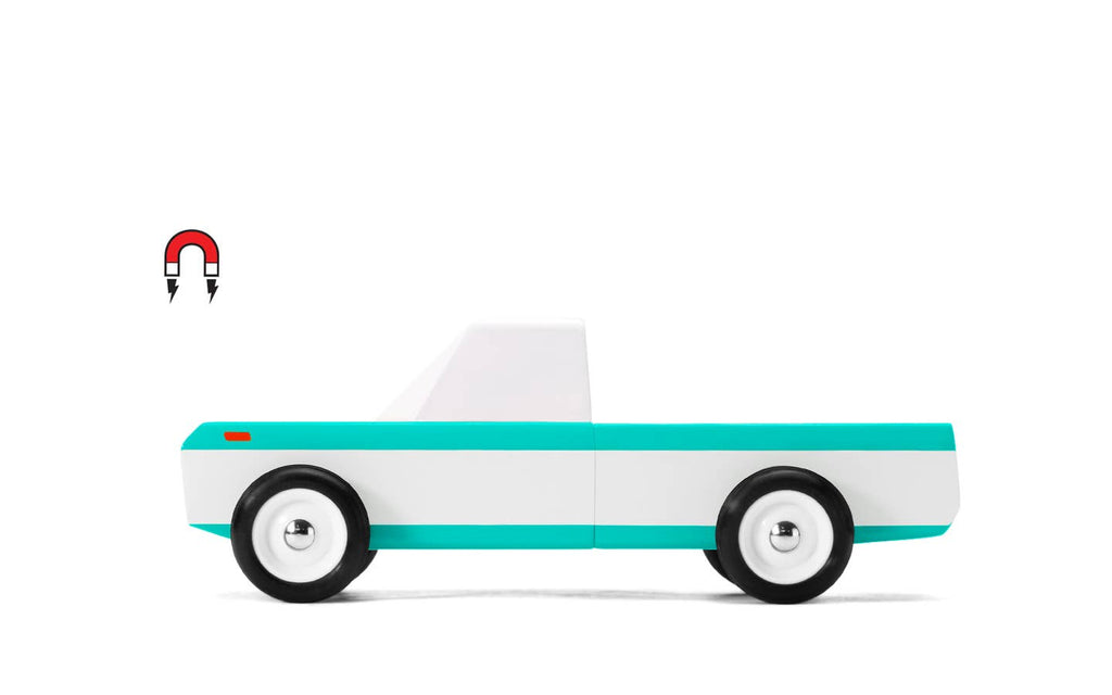 Toy truck with a white cab and teal bed on a white background