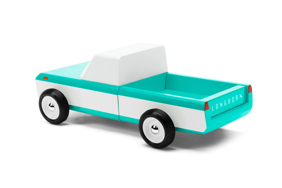 Toy truck with turquoise bed and white body on a white background
