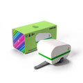 White toy caravan with green stripe next to its packaging on a white background