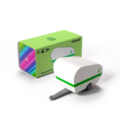 White toy caravan with green stripe next to its packaging on a white background
