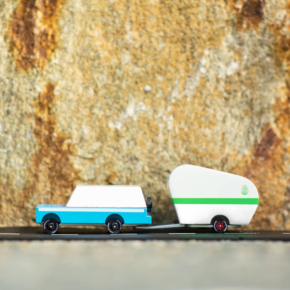 Toy truck with a camper on a textured surface