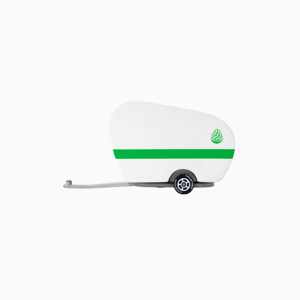 A miniature white toy trailer with a green horizontal stripe, a green pinecone logo on the rear, and a gray towing tongue, shown against a plain white background.