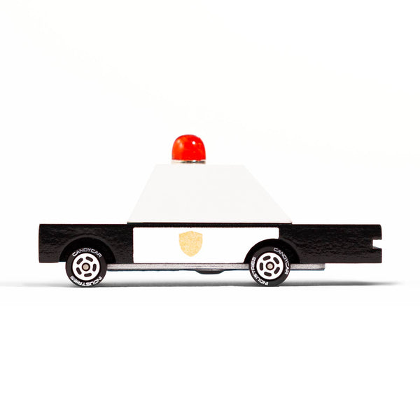 Toy police car with a red light on a white background