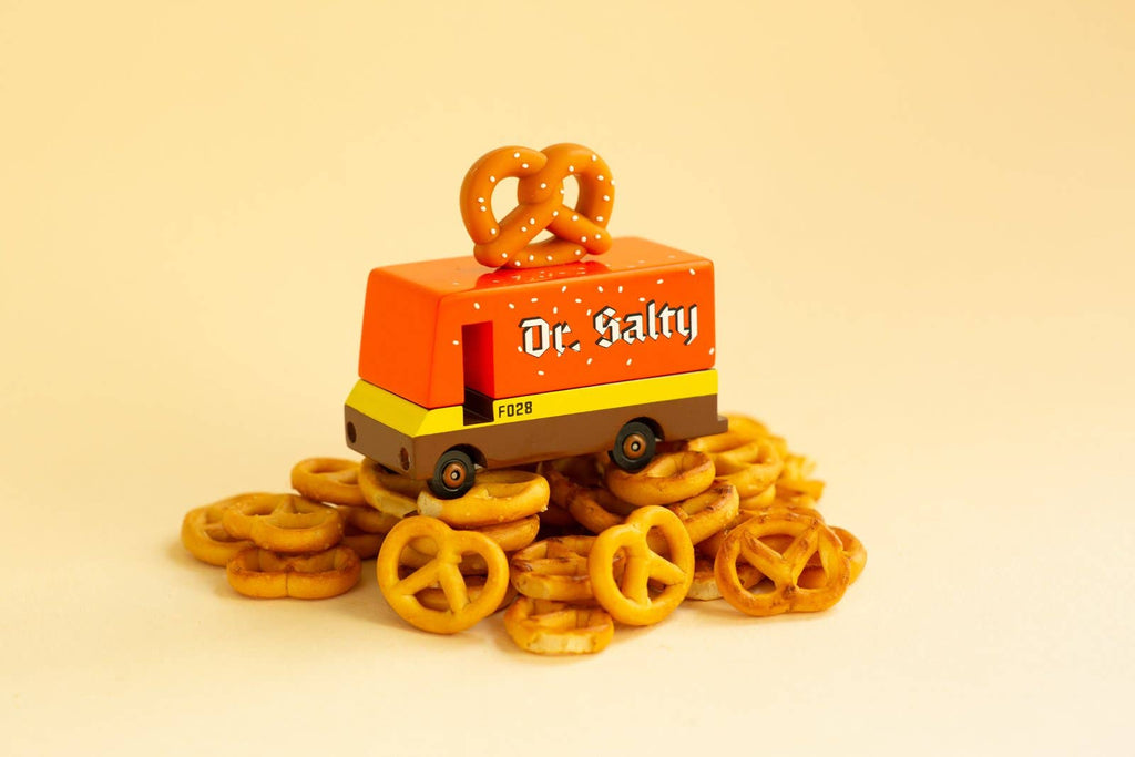 Toy pretzel themed van with pretzel on top with 'dr. salty' label on side surrounded by pretzels on tan background.