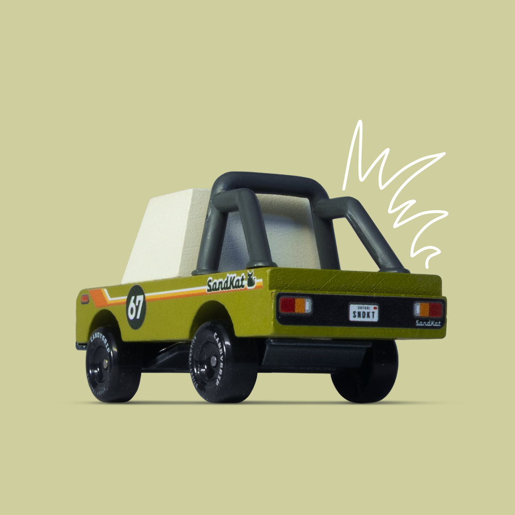 Toy truck with a white container on a beige background