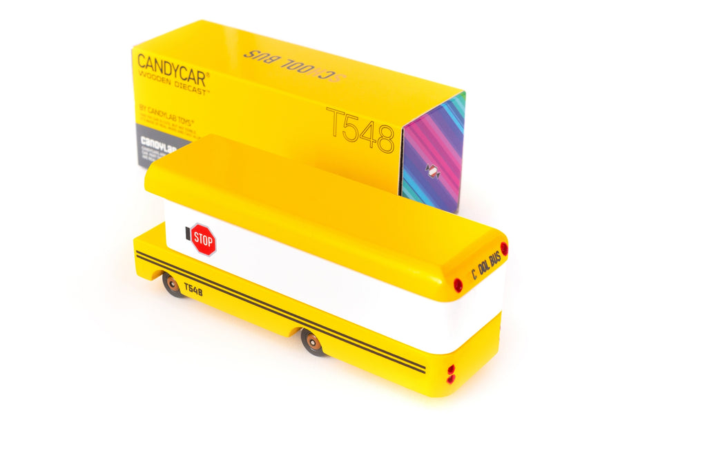 Yellow candy-shaped toy with a colorful box on a white background