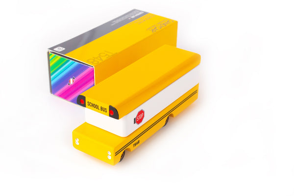 Yellow toy school bus with colorful box on a white background