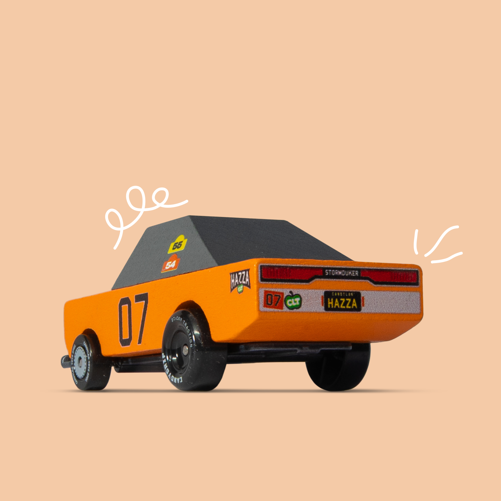 Orange toy car with black roof on a beige background
