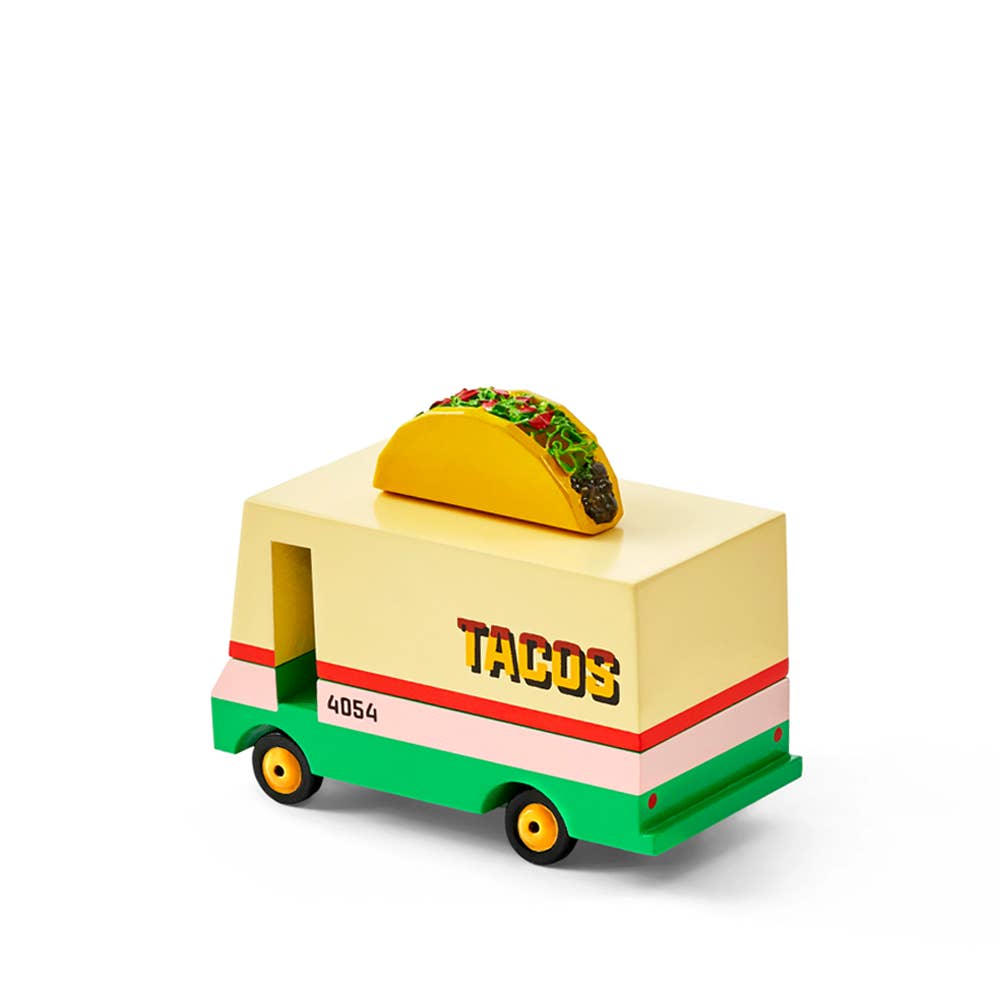 Toy taco truck with a taco on top against a white background
