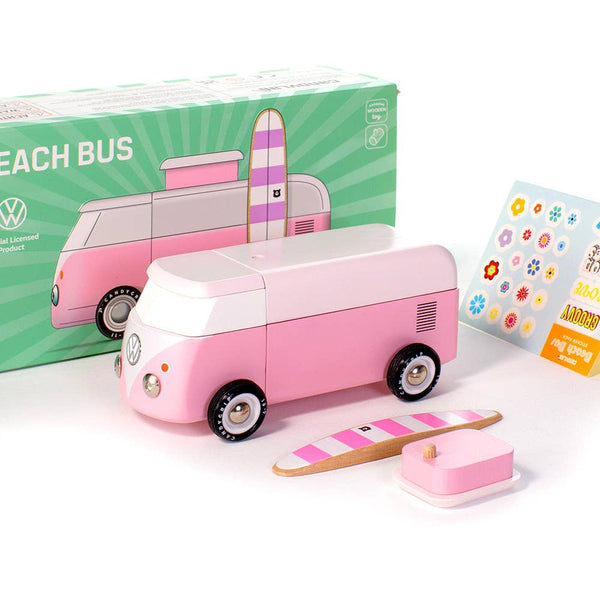 Pink toy bus with accessories and packaging on a white background