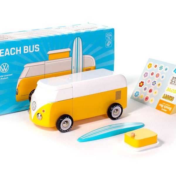 Toy Volkswagen bus with surfboard and stickers on a white background