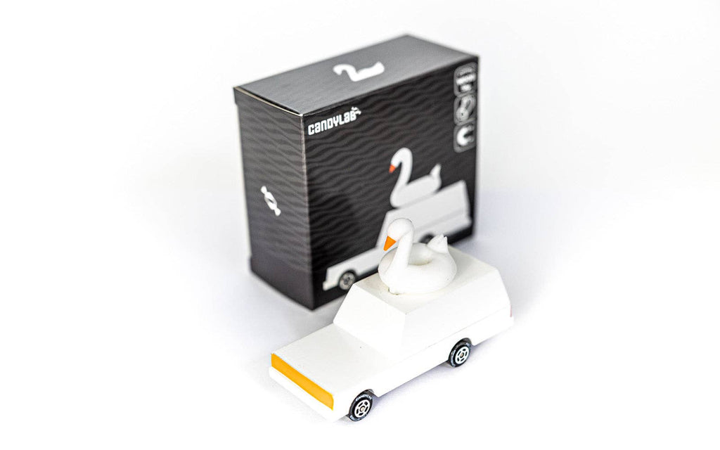White swan-shaped object with packaging on a white background