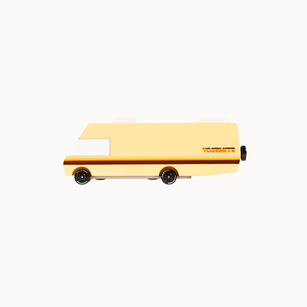 A vintage-style toy van in pale yellow with a dark brown stripe and the word 'Yosemite' printed on the side, shown against a plain white background.