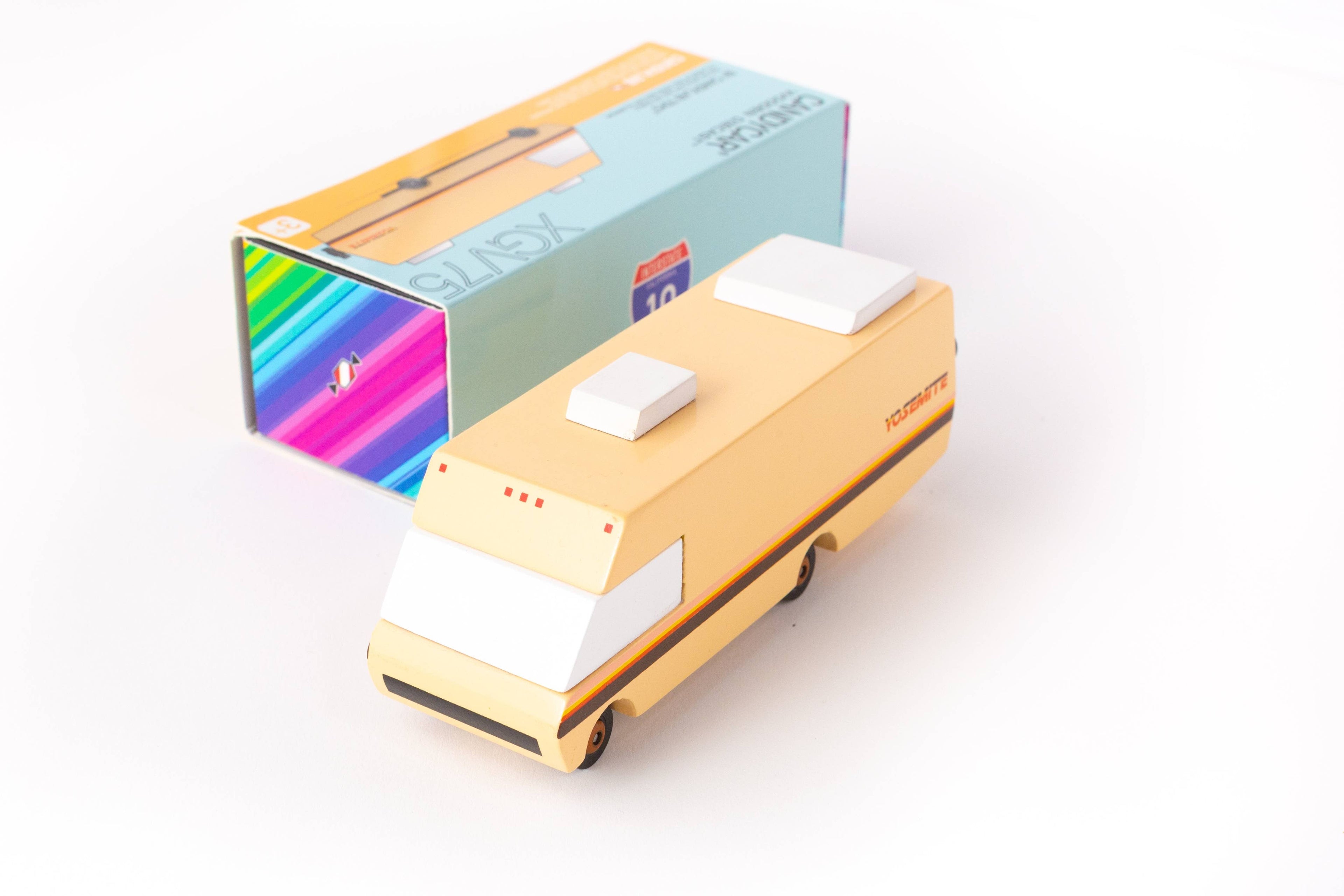 Gold rectangular device with a white square on top, next to a colorful box on a white background