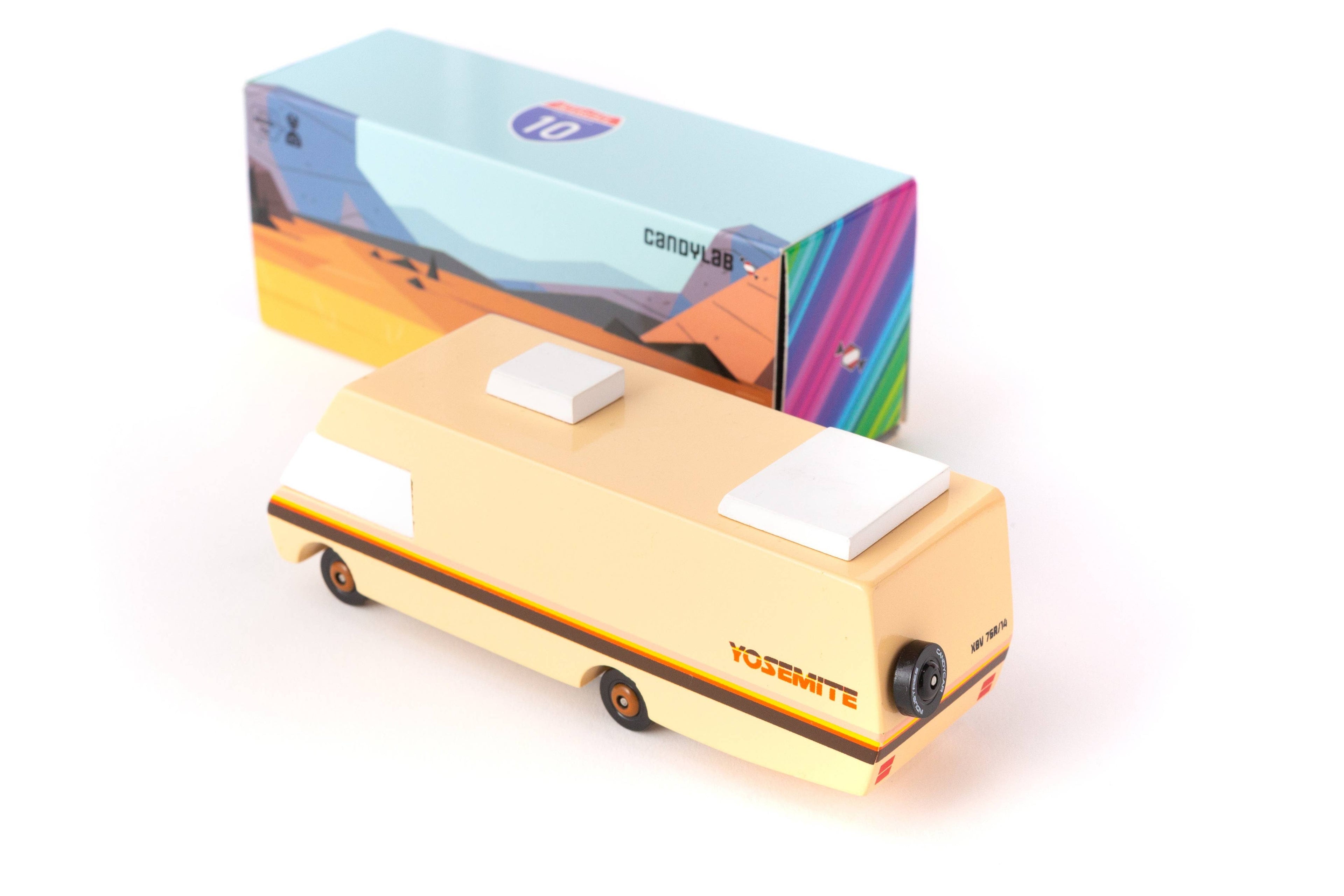 Yellow toy van with a colorful box in the background
