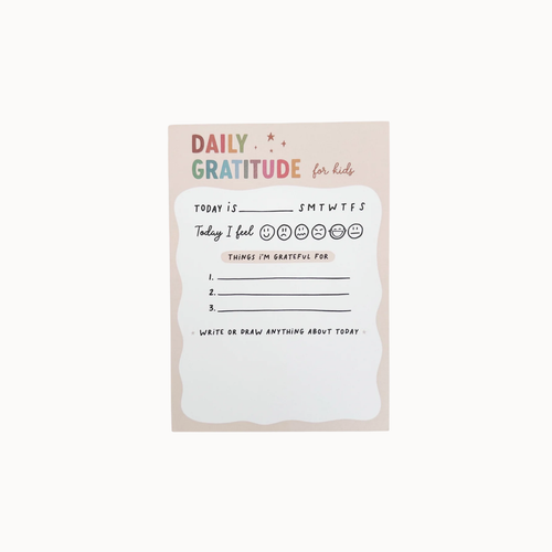 A daily gratitude card for kids with a pastel pink background and a white writing area in the center, featuring prompts like 'Today I feel' and 'Things I'm grateful for'.