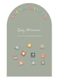Decorative board with colorful letters above a daily affirmation space and small decorative stickers below.