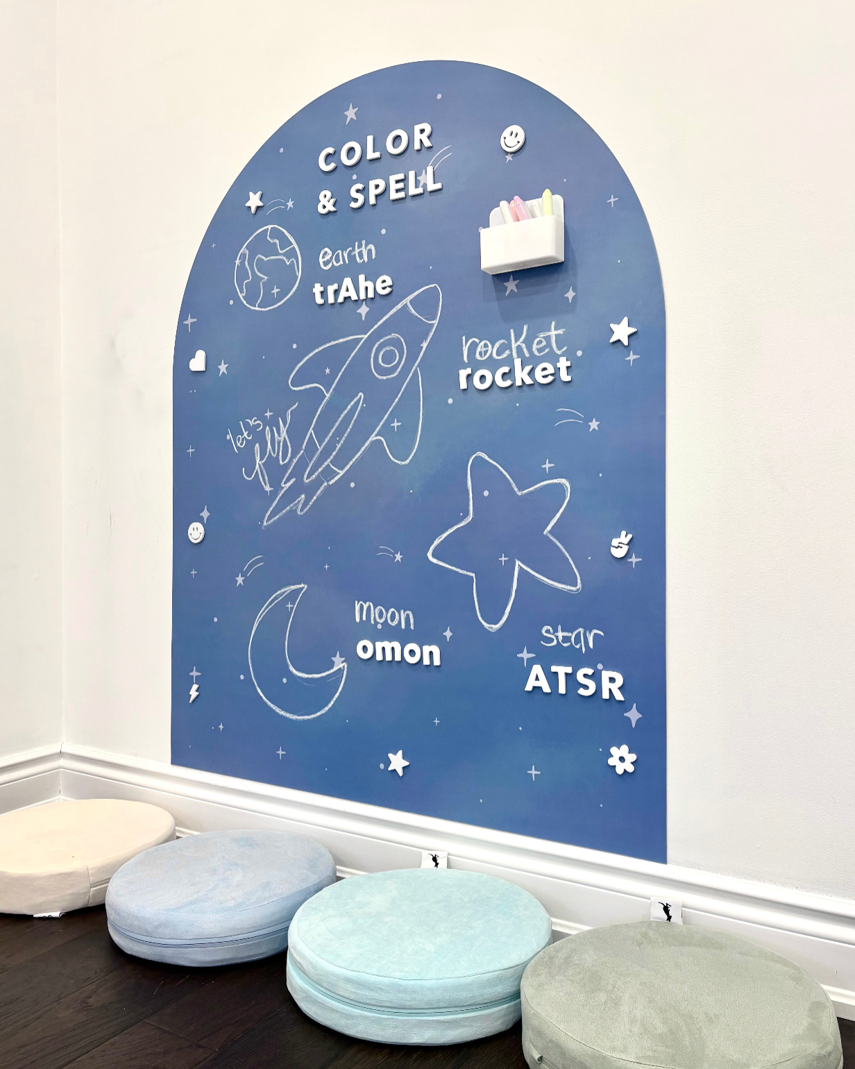 Children's educational wall chart with space-themed words and illustrations on a blue background.