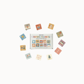 A set of colorful square 'Routine Magnets' cards arranged in a circle around their white storage box on a clean white background.