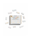 Box of sight word magnets with scattered magnetic letters on a white background