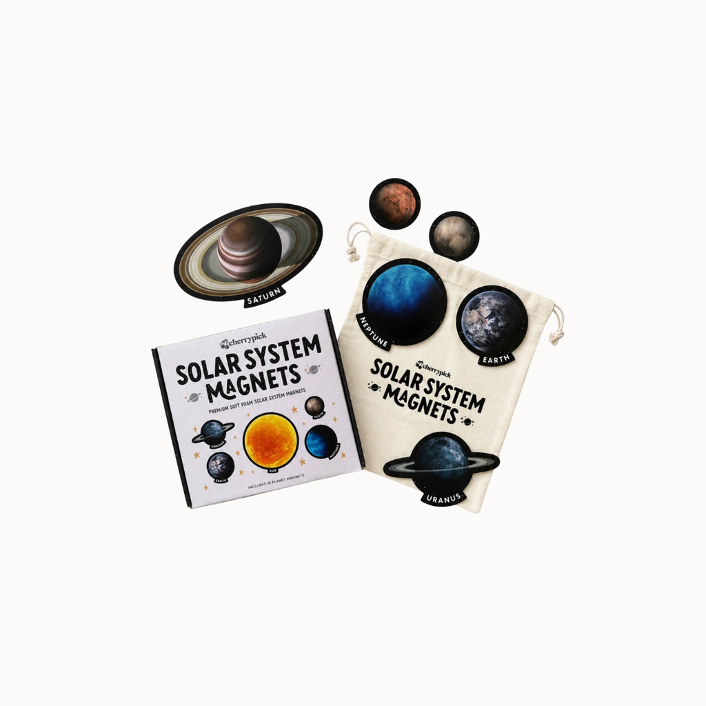A children's solar system magnets set including a book, a cream drawstring pouch, and several planet magnets, shown on a plain white background.