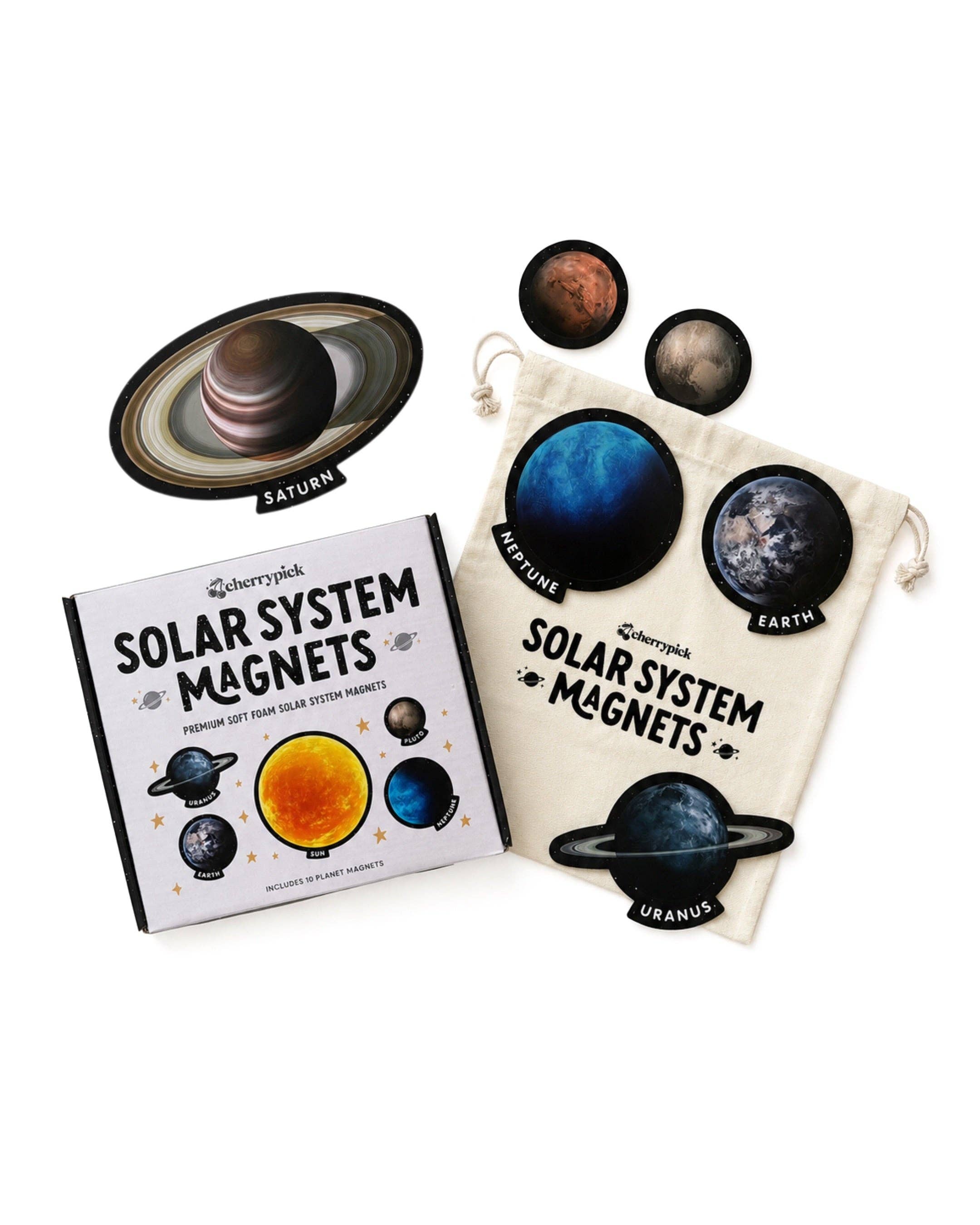 A children's solar system magnets set displayed on a white background, including a book, a cream drawstring pouch, and several planet magnets such as Saturn, Earth, Uranus, and Mars.