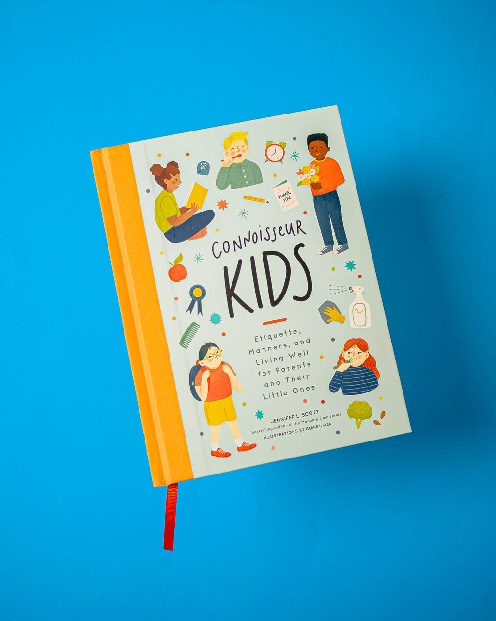 A hardcover book titled 'Connoisseur Kids' with colorful illustrations of children and educational-themed doodles on a white cover, shown floating against a bright blue background.
