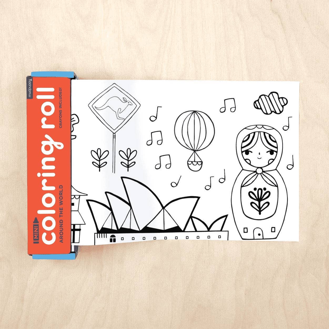 Coloring roll book with world landmarks on a wooden surface