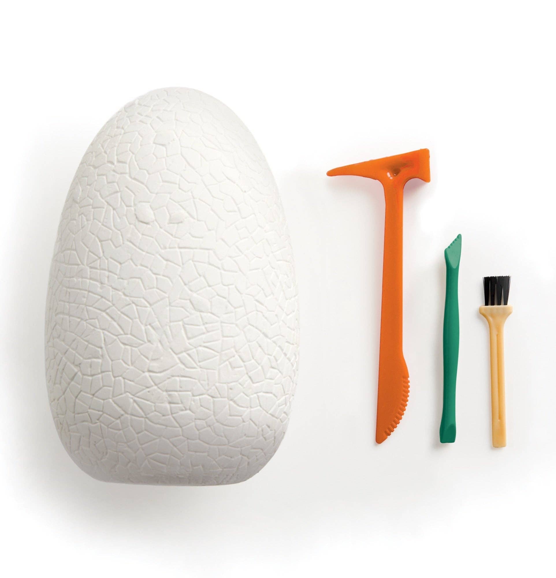 White textured egg with excavation tools on a white background