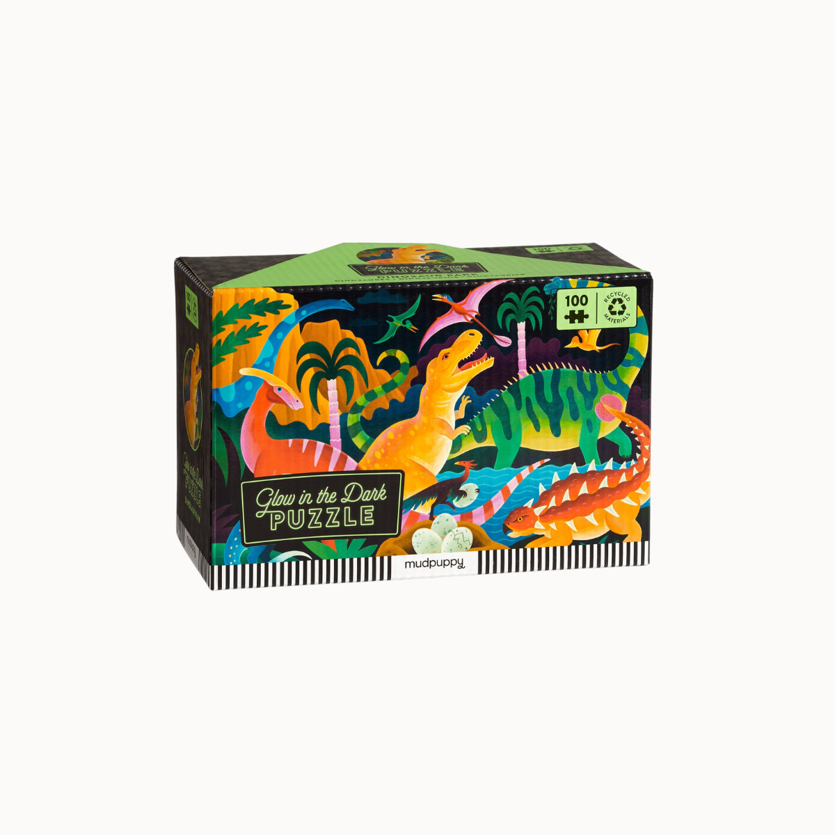 A 100-piece jigsaw puzzle box titled 'Glow in the Dark PUZZLE' by Mudbound, featuring a vibrant, colorful illustration of dinosaurs in a dark, neon-lit jungle scene.