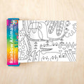 Coloring book with 'Rainbow Animals' cover and a coloring sheet on a wooden surface