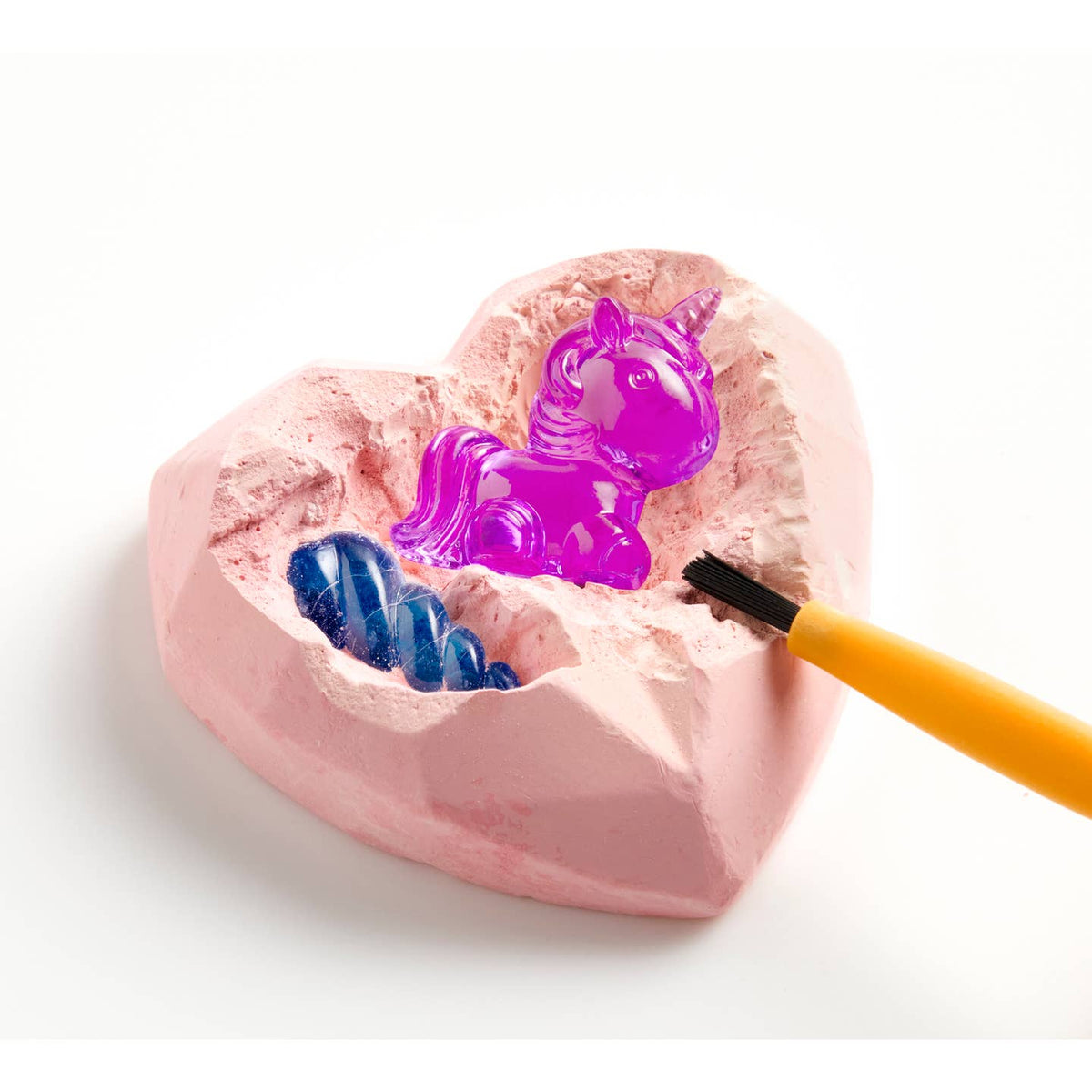 Pink heart-shaped mold with a purple unicorn and blue jelly-like substance, on a white background.